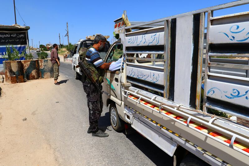 Members from a coalition of rebel groups called "Jaish al Fateh", also known as "Army of Fatah" (Conquest Army), man a checkpoint in Idlib city, Syria July 18, 2017. Picture taken July 18, 2017. REUTERS/Ammar Abdullah