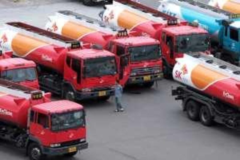 Gasoline trucks are parked at SK Energy Co.'s oil refinery in Ulsan, South Korea, on Tuesday, Sept. 23, 2008. SK Energy Co. is South Korea's biggest oil refiner. Photographer: Jean Chung/Bloomberg News



