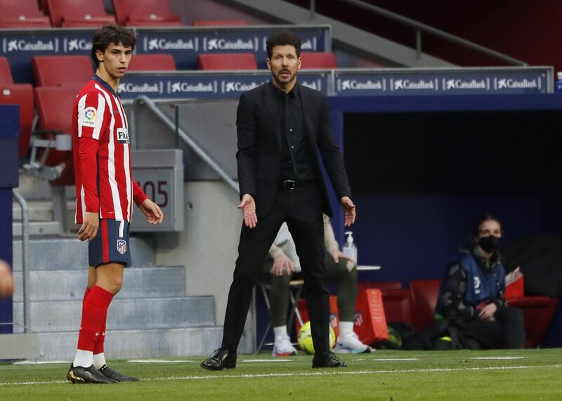 Atletico Madrid coach Diego Simeone reacts as Joao Felix looks on. Reuters