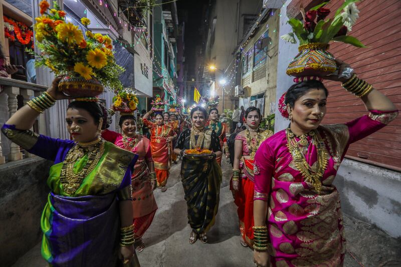 Indian women from the Koli community in traditional clothes take part in the procession to celebrate the 'Holika Dahan' or burning of Holika, in Mumbai. EPA