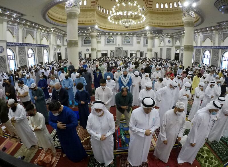 People during the morning Eid al-Fitr prayers at the Al Farooq Omar Bin Al Khattab Mosque in Dubai. Pawan Singh / The National