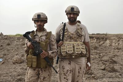 Two Emirati soldiers, part of an Arab Coalition minesweeping team, pose for a photos as they await the controlled demolition of a Houth landmine cache near Al Mokha, Yemen. Gareth Browne/The National