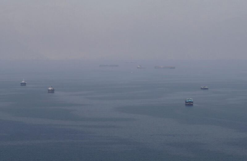 Traditional Omani boats known as dhows, and cargo ships are seen sailing towards the Strait of Hormuz, off the coast of Musandam province, Oman, July 21, 2018. Picture taken July 21, 2018. REUTERS/Hamad I Mohammed