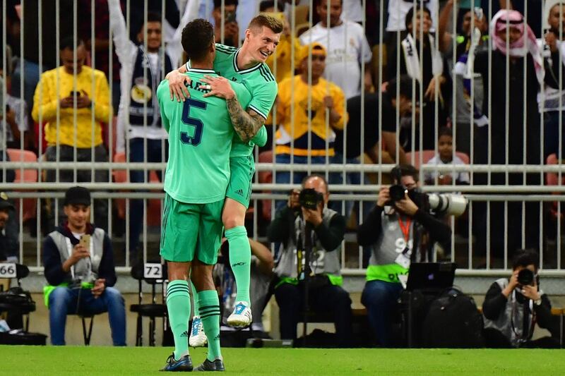 Real Madrid midfielder Toni Kroos (R) celebrates his goal with defender Raphael Varane. AFP