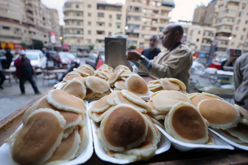 An Egyptian baker prepares 'Qatayef' at a bakery in Cairo, Egypt. EPA