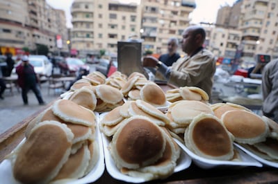 An Egyptian baker prepares 'Qatayef', a traditional pastry sold during Ramadan, at a bakery in Cairo, Egypt, last month. EPA