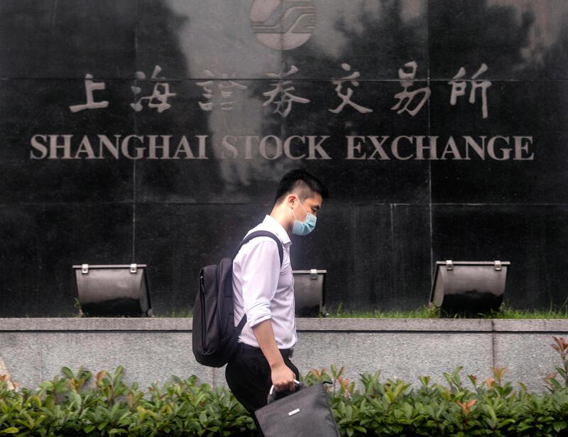 epa08535746 A man walks in front of the Stock Exchange Building in Shanghai, China, 08 July 2020 (issued 09 July 2020). China's Consumer Price Index (CPI), a main gauge of inflation, is rose 2.5 percent year-on-year in June 2020, according to National Bureau of Statistics report published on 09 June 2020, for the fifth consecutive month. The Producer-Price Index (PPI) dropped 3.0 percent year-on-year in June 2020.  EPA/ALEX PLAVEVSKI