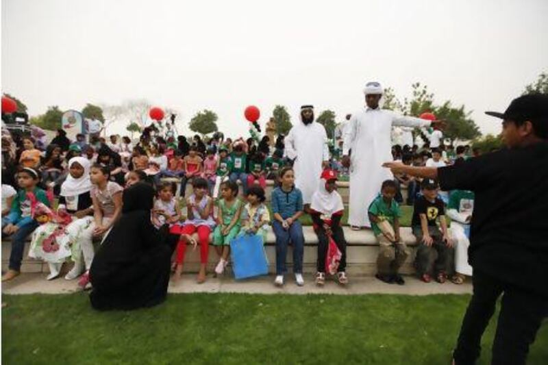 Volunteers with children before a show as part of the third Arab Orphan Day Ceremony held by Dar Al Ber Society in Dubai in April. Sarah Dea / The National