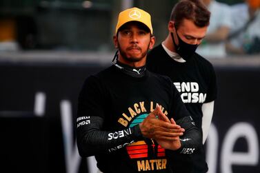 Mercedes' British driver Lewis Hamilton (C) takes part in the End Racism event ahead of the Abu Dhabi Formula One Grand Prix at the Yas Marina Circuit in the Emirati city of Abu Dhabi on December 13, 2020. / AFP / POOL / HAMAD I MOHAMMED
