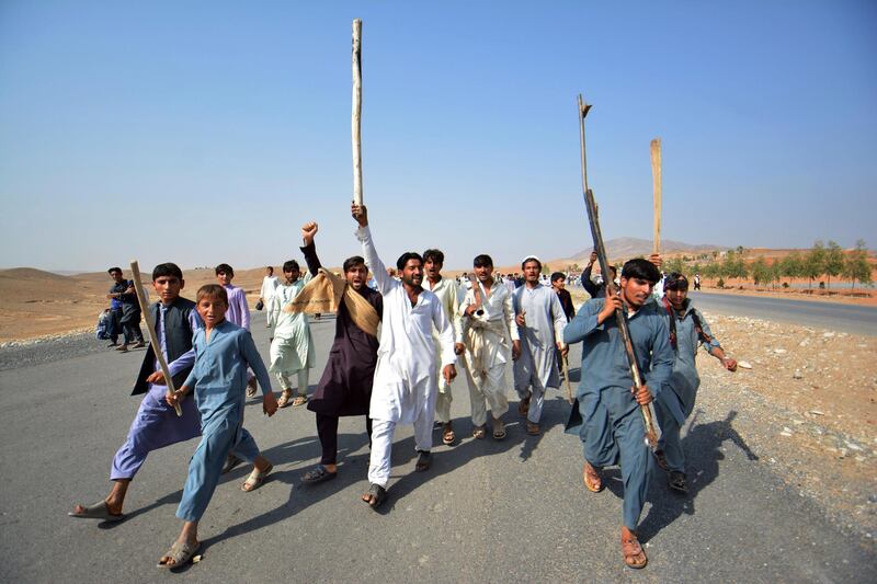 Afghans shout slogans against the government after a military operation left many civilians dead in Rodat district of Nangarhar province, east of Kabul, Afghanistan, Wednesday, Oct. 24, 2018. An Afghan official says hundreds of villagers have blocked a major highway in eastern Nangarhar province to denounce the killings of civilians during an ongoing military operation against militants there. (AP Photo/Mohammad Anwar Danishyar)