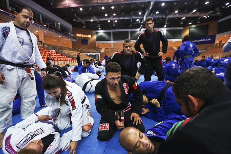 Renzo Gracie, centre, gives tips on Brazilian jiu-jitsu during a workshop for instructors on August 28, 2014, at the FGB Arena at Zayed Sports City in Abu Dhabi. Delores Johnson / The National