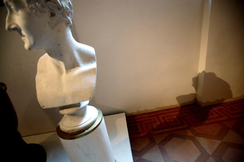 The 'Bust of Leopoldo Cicognara' by Antonio Canova casts its shadow against a wall showing a dark stain indicating the level the water reached during the latest high tide flooding, at the Accademia Gallery, in Venice. Luca Bruno / AP Photo