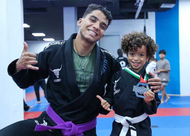Adel Ibrahim, 5, and his Jiu-Jitsu coach, Mohamed Karim. Victor Besa / The National