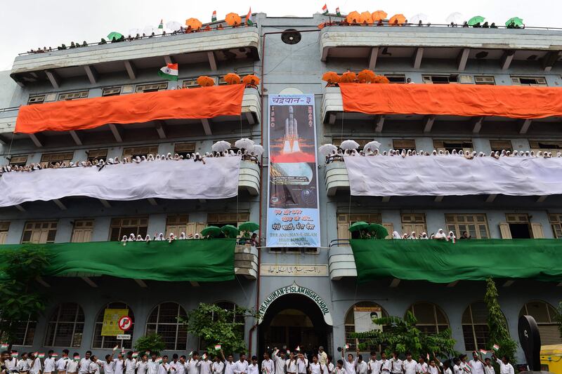 Students wave Indian flags at the Anjuman E Islam High School. AFP