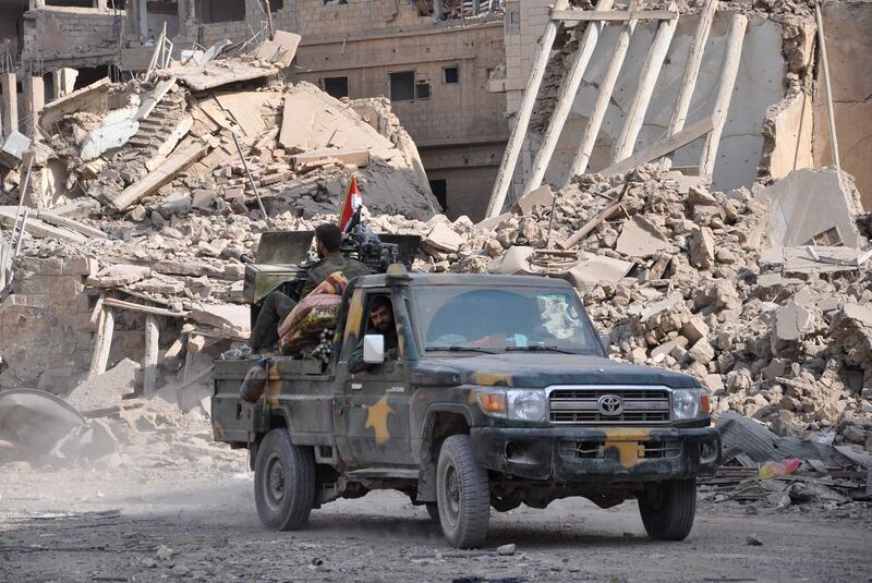 Syrian pro-government forces patrol in the eastern city of Deir Ezzor on November 4, 2017.
Syrian and allied forces converged on holdout Islamic State group fighters in the Syrian border town of Albu Kamal, the jihadists' very last urban bastion following a string of losses. On November 3, Russian-backed Syrian regime forces took full control of Deir Ezzor, which was the last city where IS still had a presence after being expelled from Hawija and Raqa last month
 / AFP PHOTO / STRINGER