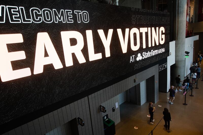 Voters wearing protective masks stand in line to cast ballots at an early voting polling location for the 2020 Presidential elections in Atlanta, Georgia, U.S. Bloomberg