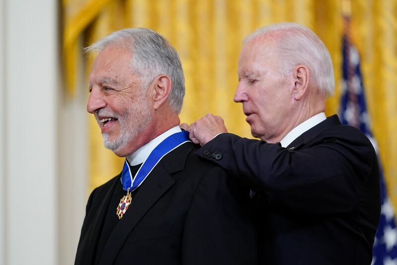 President Joe Biden awards Father Alexander Karloutsos, the former Vicar General of the Greek Orthodox Archdiocese of America, with the Presidential Medal of Freedom, the highest US civilian honour, at a ceremony in the White House's East Room.  AP