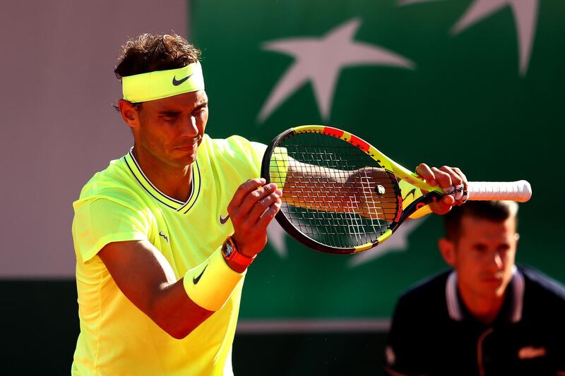 Nadal checks his racket. Getty