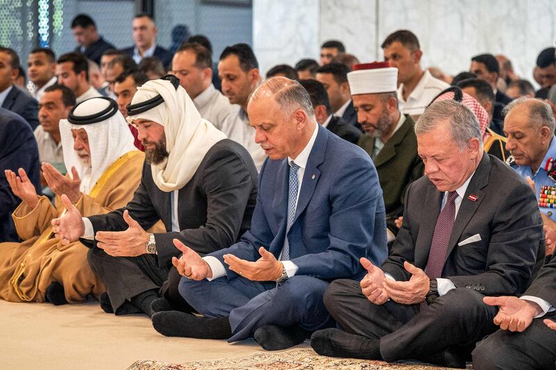Jordan's King Abdullah II, right, performs Eid Al Adha morning prayers the Hashemiya mosque in Amman. AFP