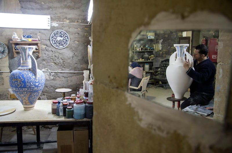 An artist works on a replica of Islamic antiquity piece at the Replica Production Unit located at Salah Al Din Citadel in Cairo, Egypt.  EPA