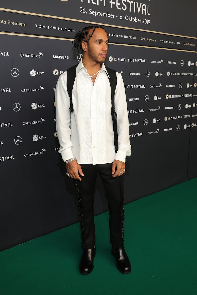 Lewis Hamilton, in a white shirt and black accessories, attends the 'Le Mans '66' premiere on October 04, 2019, in Zurich, Switzerland. Getty Images