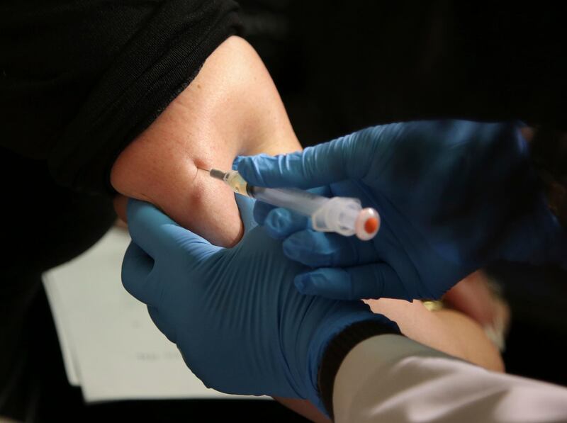 FILE - In this March 27, 2019, file photo, a woman receives a measles, mumps and rubella vaccine at the Rockland County Health Department in Pomona, N.Y. The Centers for Disease Control and Prevention reports that U.S. measles cases have surged this year, and at this pace will set a record for most illnesses in 25 years. Nearly two-thirds of the cases reported have been in New York, and most of those have been unvaccinated people in Orthodox Jewish communities. (AP Photo/Seth Wenig, File)