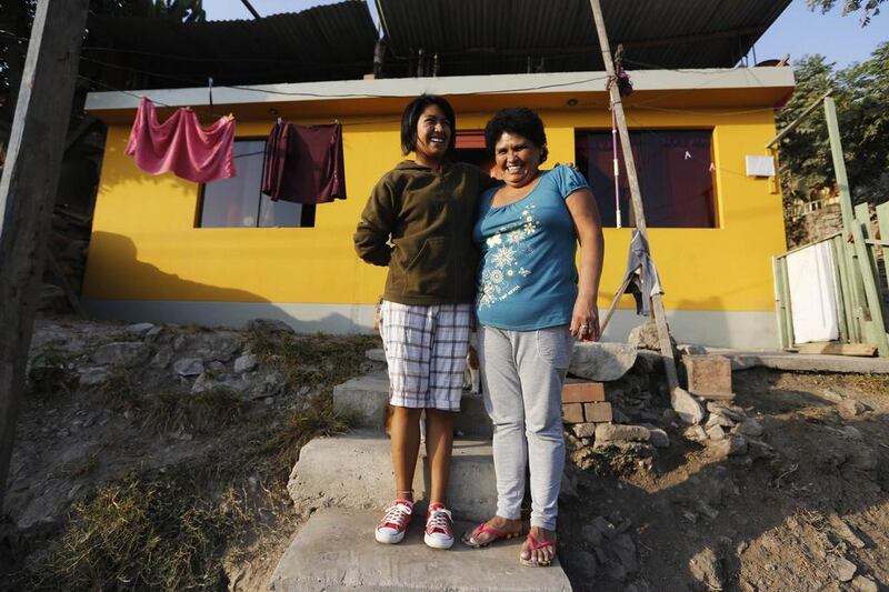 Graciela Guzman (right) and her daughter Maria in front of their home in Gosen City. Guzman was one of the founders of Gosen City more than 12 years ago, and managed to build her own home in 2009. Her daughter Maria studies graphic design in Lima. Mariana Bazo / Reuters