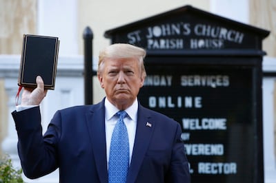 US President Donald Trump holds a Bible as he visits outside St John's Church in Washington in June 2020. AP Photo