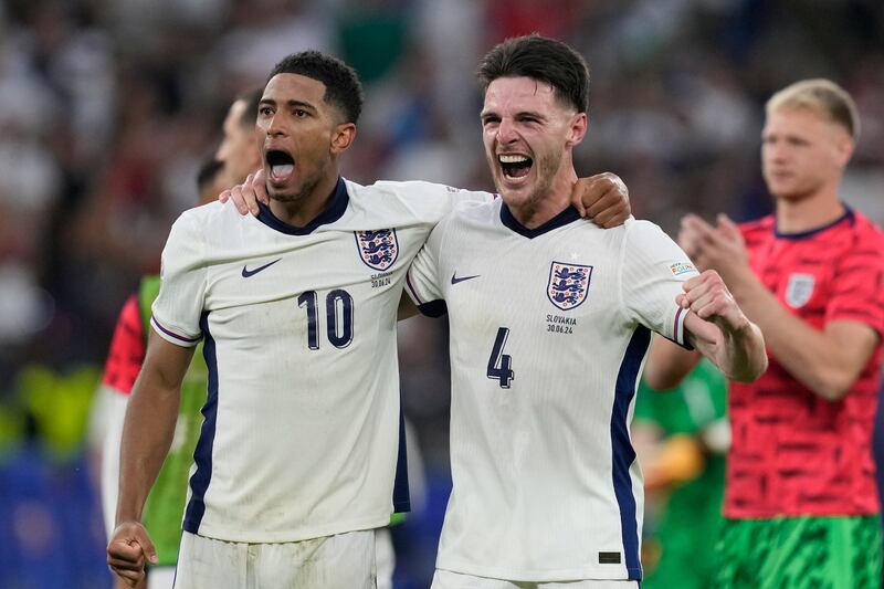 England's Jude Bellingham and Declan Rice celebrate at the end of their 2-1 last-16 extra-time victory against Slovakia at Euro 2024 in Gelsenkirchen on June 30, 2024. AP 