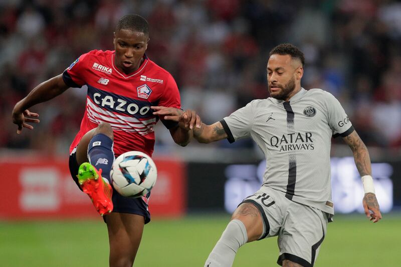 PSG's Neymar, right, challenges with Lille's Bafode Diakite. AP Photo 