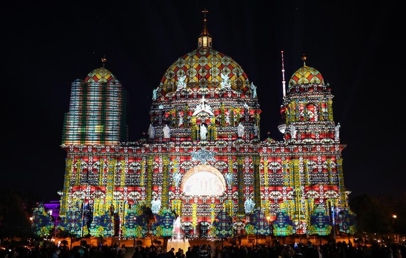 Visitors look at a light projection on the Berlin Cathedral during the illumination festival 'Berlin leuchtet' (Berlin illuminated), in Germany. EPA