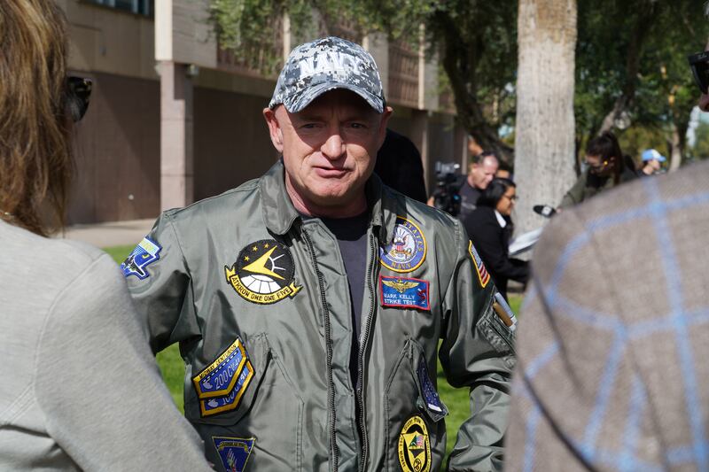 Senator Mark Kelly speaks with supporters ahead of a campaign event in Phoenix. Willy Lowry / The National