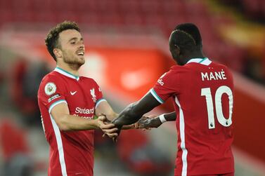 Liverpool's Diogo Jota, left celebrates with Liverpool's Sadio Mane after he scored his sides second goal of the game during the English Premier League soccer match between Liverpool and Sheffield United at Anfield in Liverpool, England, Saturday, Oct. 24, 2020. (Stu Forster/Pool via AP)