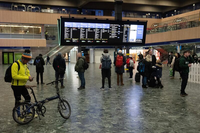 Passengers check the departure boards at Euston station. Getty Images