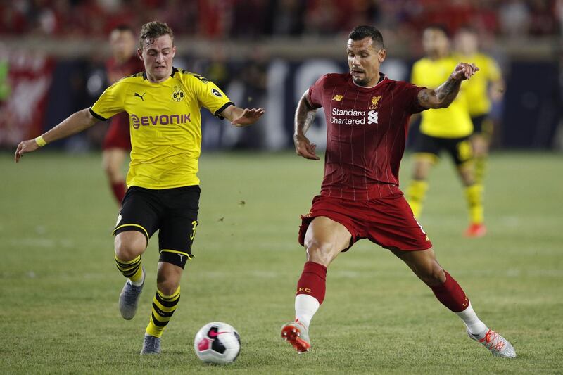 Dejan Lovren is challenged by Dortmund's Jacob Bruun Larsen. AFP