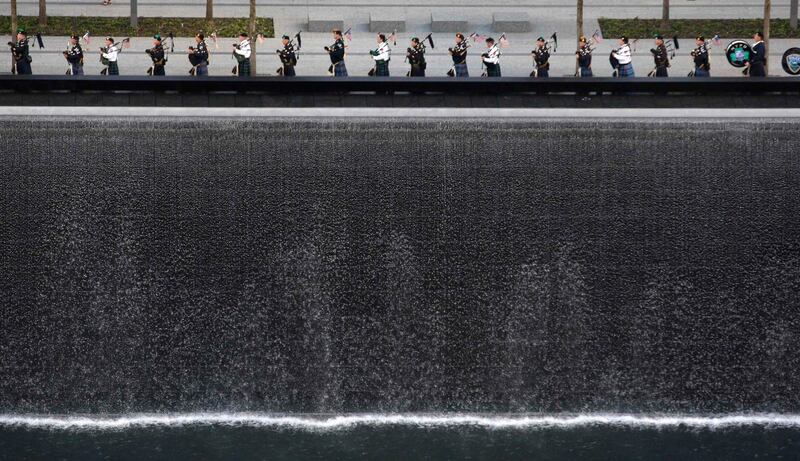 Bagpipers perform next to one of the Memorial's twin pools at Ground Zero during ceremonies marking the 10th anniversary of the 9/11 attacks on the World Trade Center, in New York, September 11, 2011. REUTERS/Jessica Rinaldi (UNITED STATES - Tags: ANNIVERSARY DISASTER TPX IMAGES OF THE DAY) *** Local Caption ***  WTC111_SEPT11-_0911_11.JPG
