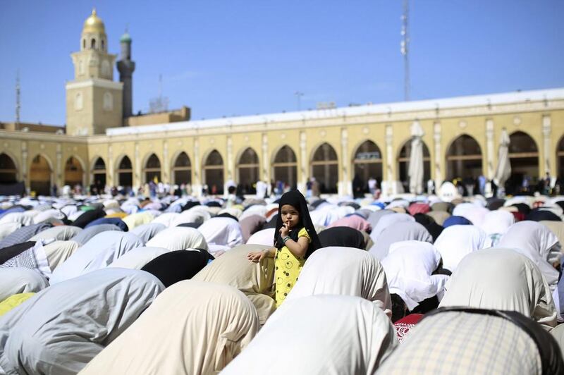 A girl stands amidst people attending Friday prayer in Najaf, south of Baghdad, Iraq. Ahmad Mousa / Reuters / March 28, 2014  