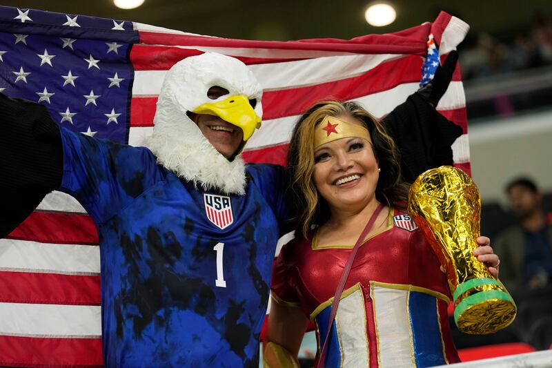 USA supporters wave the stars and stripes before playing Wales, at the Ahmad bin Ali Stadium in Umm Al Afaei, a match that was drawn 1-1. AP