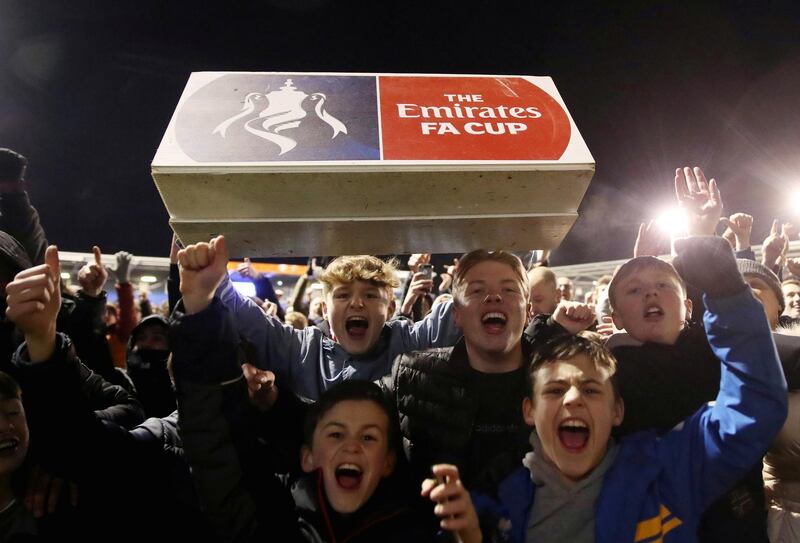 Shrewsbury Town fans invade the pitch to celebrate after the match. Reuters