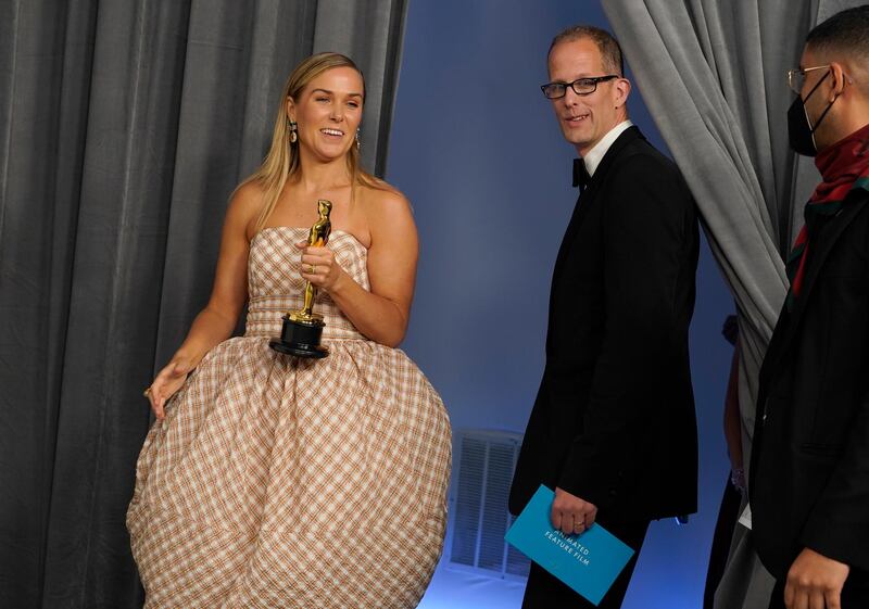 Dana Murray, left, and Pete Docter, winners of the award for Best Animated Feature Film for 'Soul', enter the press room at the Academy Awards in Los Angeles, California. AP