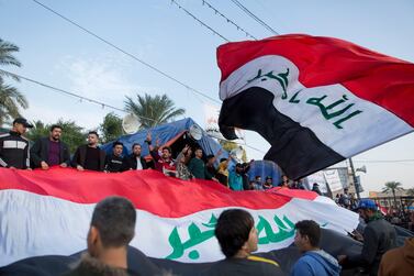 Activists chant anti-government slogans in Tahrir Square, in Baghdad, Iraq. Nasser Nasser / AP