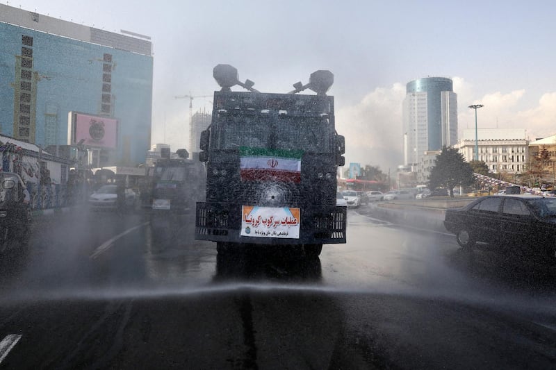A police vehicle disinfects streets against coronavirus in Tehran, Iran. AP Photo