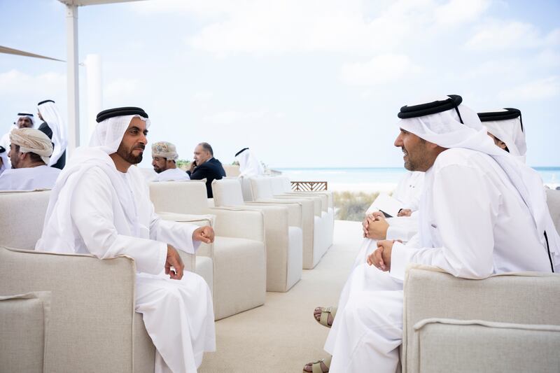 Sheikh Saif speaks with a guest

