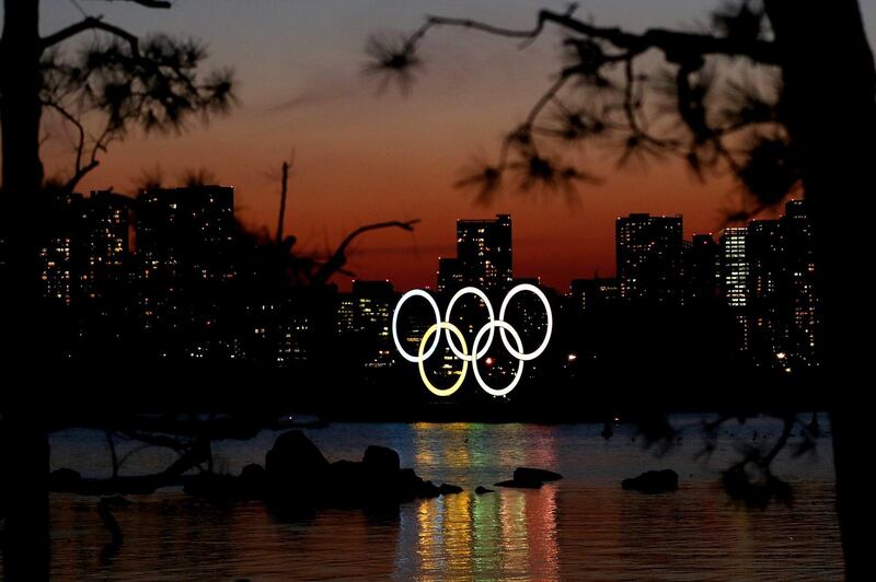 The sun sets behind an Olympic rings installation at Odaiba Marine Park in Tokyo, Japan. Getty Images