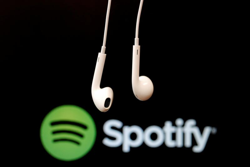 FILE PHOTO: Headphones are seen in front of a logo of online music streaming service Spotify in this  February 18, 2014 illustration picture. REUTERS/Christian Hartmann/File Photo