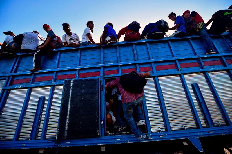 Honduran migrants heading in a caravan to the US, board a truck in Metapa on their way to Tapachula, Chiapas state, Mexico. AFP Photo