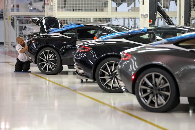 FILE: An employee checks the rear of an Aston Martin DB11 luxury automobile in the quality inspection area at Aston Martin Lagonda Ltd.'s manufacturing and assembly plant in Gaydon, U.K., on Tuesday, June 6, 2017. Aston Martin is targeting a valuation of as much as 5 billion pounds ($6.8 billion) in a potential initial public offering of the British sports car maker, according to people familiar with the matter. Photographer: Chris Ratcliffe/Bloomberg