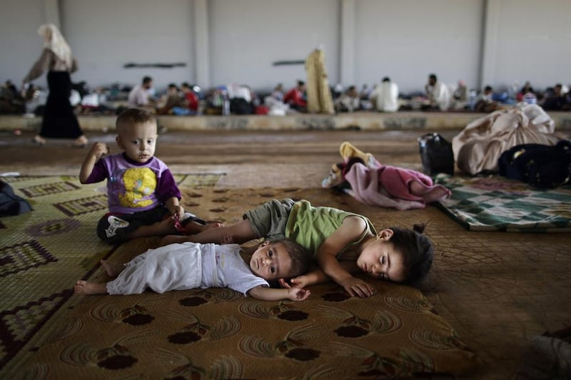 Syrian children take refuge at the Bab Al-Salameh border crossing. Muhammed Muheisen / AP