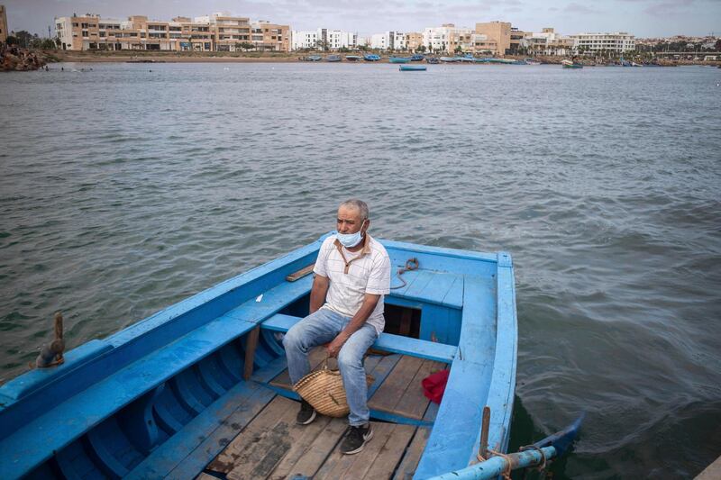 A man crosses by boat from Rabat to Sale after lockdown measures were lifted, in Morocco. AP Photo