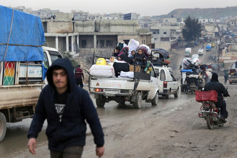 Syrian flee the advance of the government forces in the province of Idlib, Syria, towards the Turkish border, Thursday, Jan. 30, 2020. Warplanes struck a town in a rebel-held enclave in northwestern Syria, killing several people, including some who were fleeing the attack, opposition activists and a rescue service said Thursday. The attack, believed to have been carried out by Russian warplanes backing a Syrian government offensive, also put a local hospital out of service, they said. (AP Photo/Ghaith Alsayed)